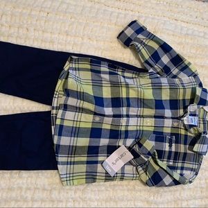 Baby boy green flannel buttondown with blue pants.